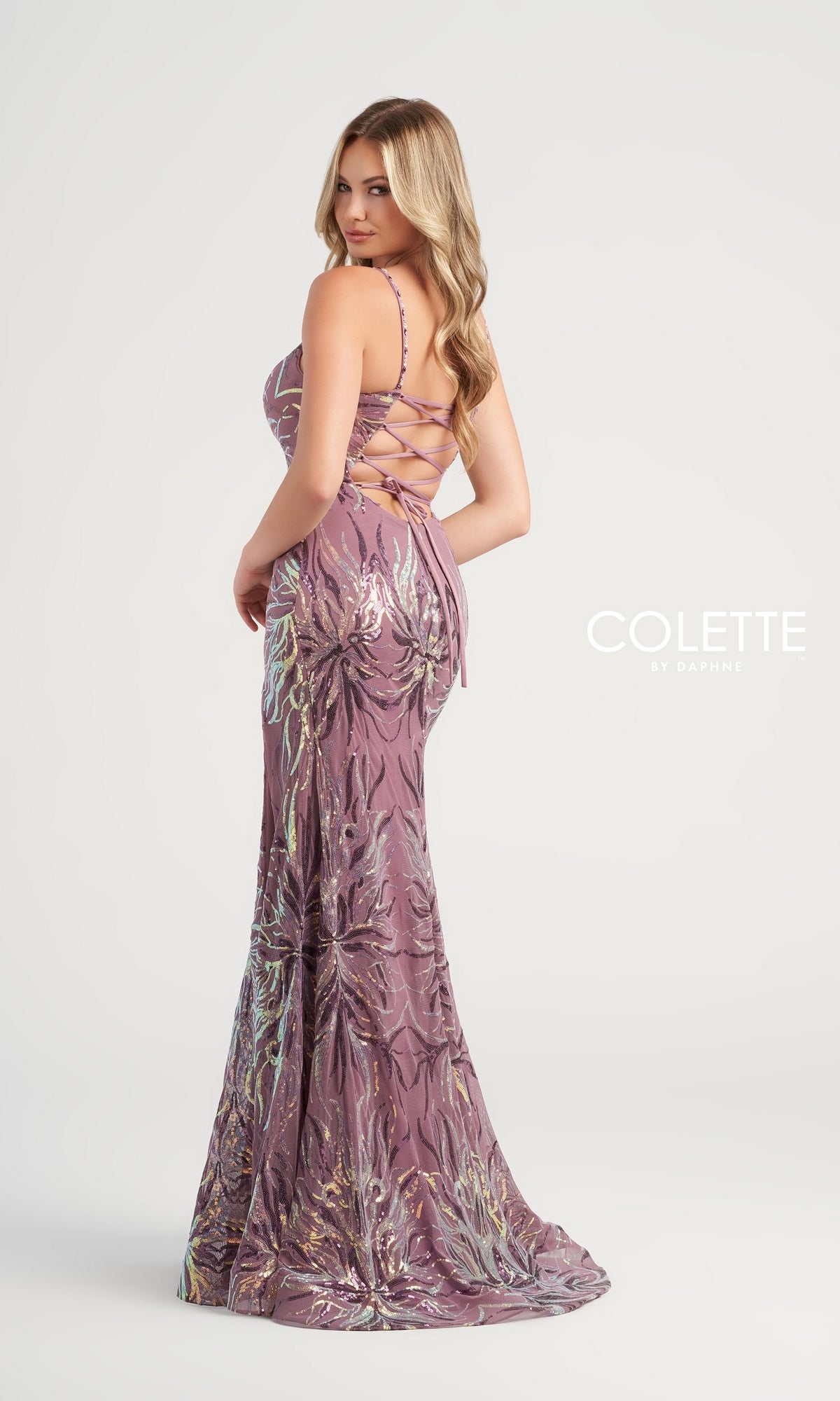 A woman models the Sequin-Print Colette Long Prom Dress CL5195, a fitted, floor-length mauve gown with a lace-up back and sparkling sequins. She looks over her shoulder against a plain white background with